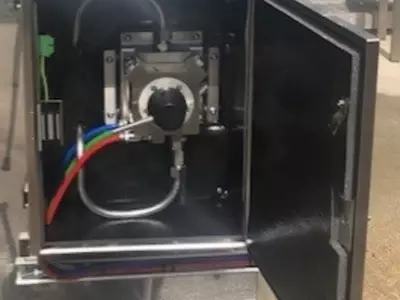 Close-up view of the Kothar Turn & Clean system installed within the cabinet. This unit allows seamless switching between multiple detergents, enabling a controlled 3-stage cleaning process for effective vehicle washdown.